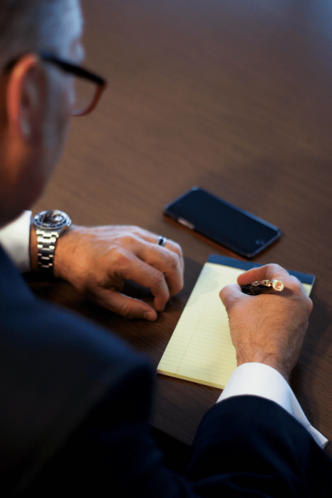 business man writing on paper
