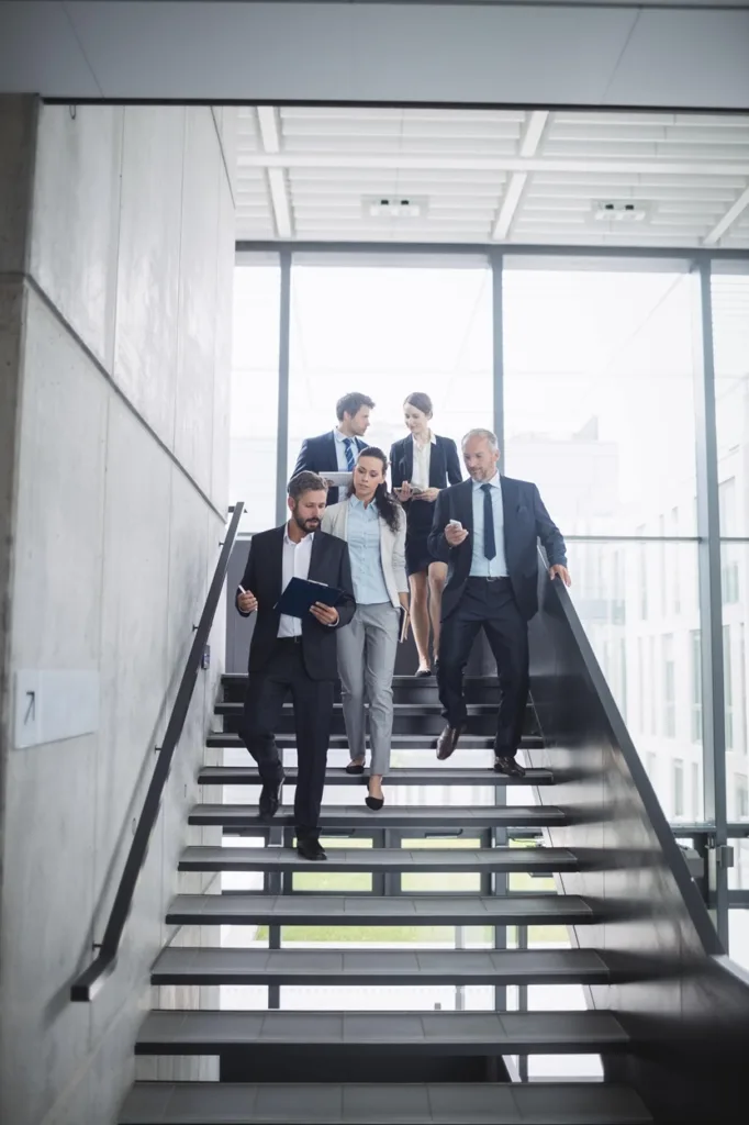business people walking down a stairs