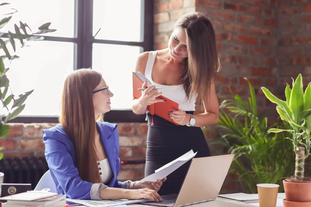 two women speaking in an office